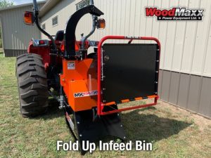 An orange american made wood chipper with a black fold up infeed bin attatched to the front.